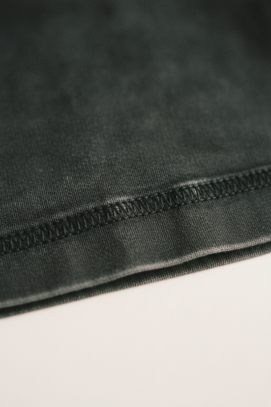 Washed black heavyweight cotton hem detail, overlock stitch, clean fold, echelonn. HQ 001