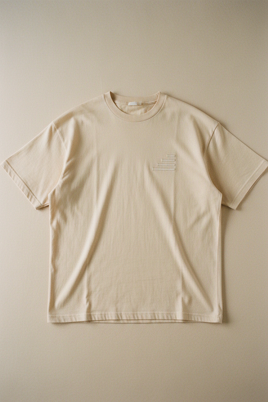 echelonn. peplos. oversized heavyweight t-shirt flat lay — stone colourway, tonal four-bar mark on left chest, dense ring-spun cotton